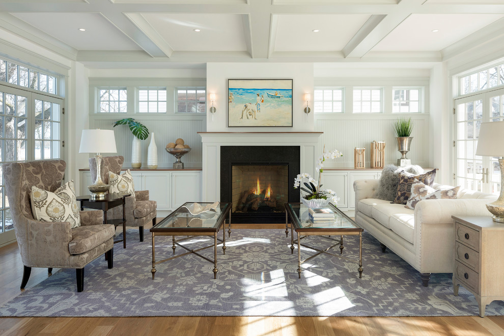 Large beach style formal living room in Minneapolis with white walls, light hardwood floors, a standard fireplace and a stone fireplace surround.