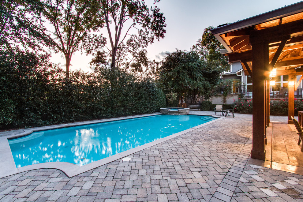 Design ideas for a large country backyard rectangular lap pool in Nashville with brick pavers.