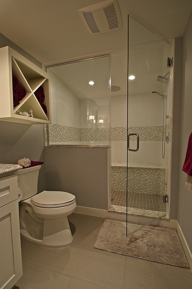 Photo of a mid-sized contemporary bathroom in Minneapolis with an alcove shower, a hinged shower door, shaker cabinets, white cabinets, white tile, beige walls, an undermount sink and beige floor.