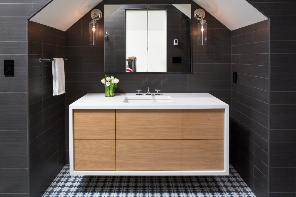 This is an example of a mid-sized modern 3/4 bathroom in Minneapolis with flat-panel cabinets, light wood cabinets, black tile, black walls, an undermount sink, granite benchtops, white benchtops, a single vanity and a floating vanity.