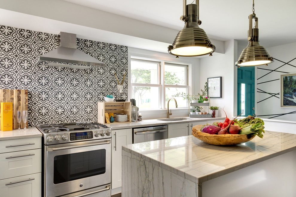 Photo of a transitional single-wall kitchen in Minneapolis with an undermount sink, shaker cabinets, white cabinets, marble benchtops, multi-coloured splashback, ceramic splashback, stainless steel appliances and with island.