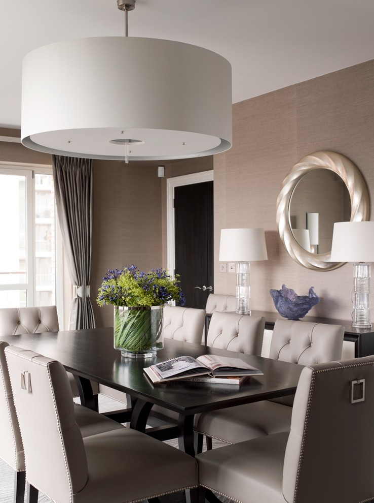 Photo of a large transitional separate dining room in London with beige walls.