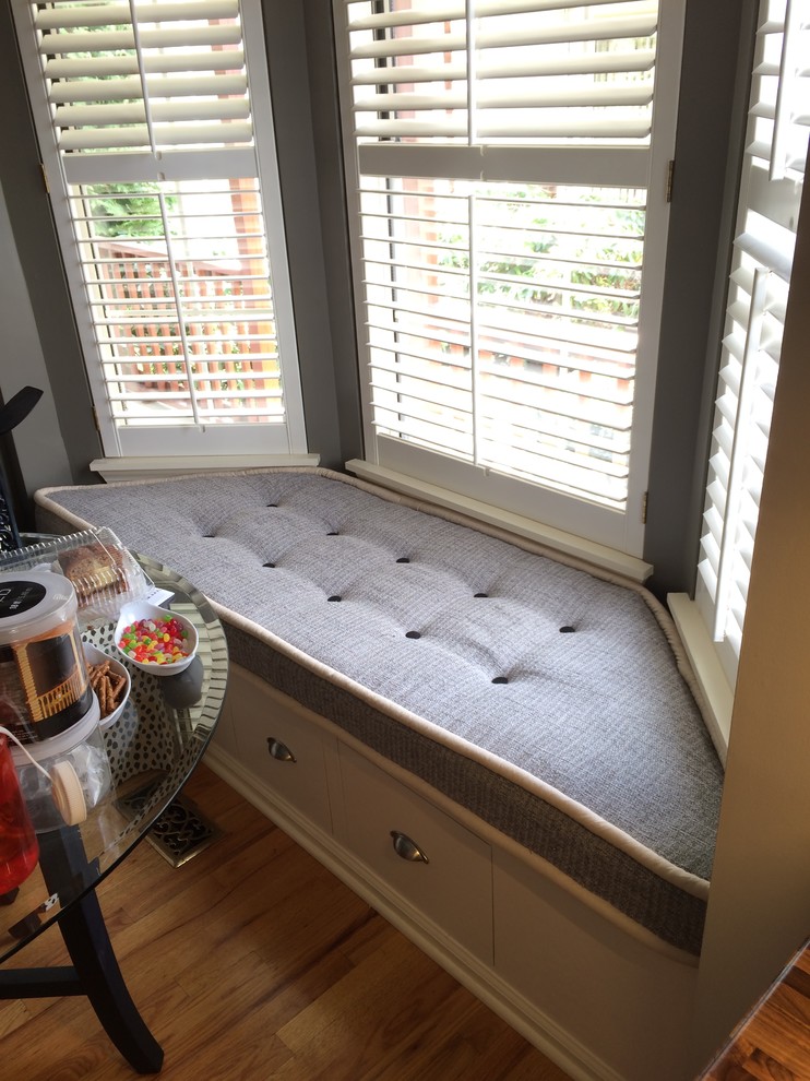 Inspiration for a mid-sized transitional galley light wood floor eat-in kitchen remodel with an undermount sink, raised-panel cabinets, white cabinets, wood countertops, white backsplash, stone tile backsplash, stainless steel appliances and no island