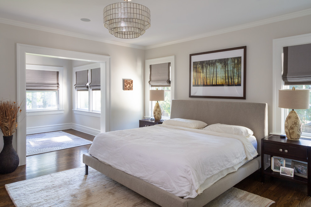 Transitional bedroom in New York with grey walls, dark hardwood floors and brown floor.