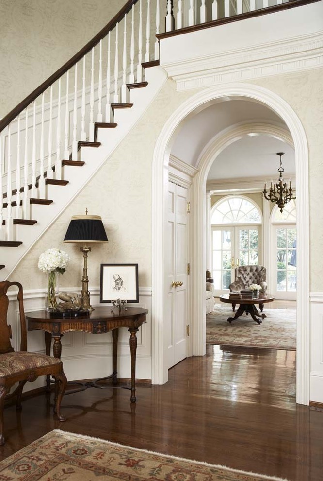 This is an example of a large traditional foyer in Other with beige walls and medium hardwood floors.