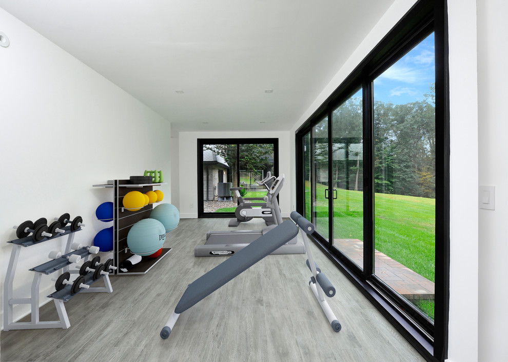 Inspiration for a large contemporary multipurpose gym in New York with white walls and grey floor.
