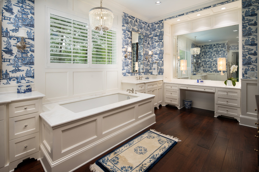 Large traditional bathroom in Houston with shaker cabinets, white cabinets, a drop-in tub, blue tile, blue walls, medium hardwood floors and quartzite benchtops.