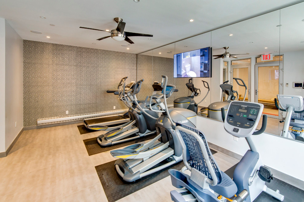 Contemporary home gym in New York with grey walls and porcelain floors.
