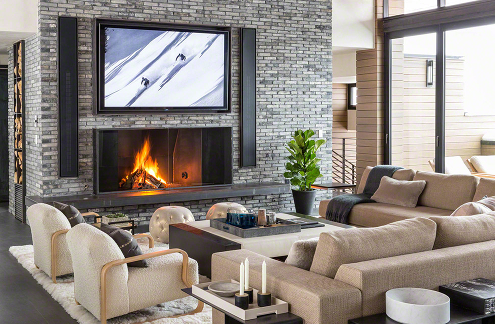 Contemporary formal open concept living room in Phoenix with multi-coloured walls, a standard fireplace, a brick fireplace surround, a wall-mounted tv and grey floor.