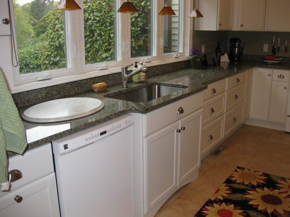Kitchen - transitional l-shaped ceramic tile and beige floor kitchen idea in Boston with an undermount sink, shaker cabinets, white cabinets, granite countertops, white appliances and green countertops