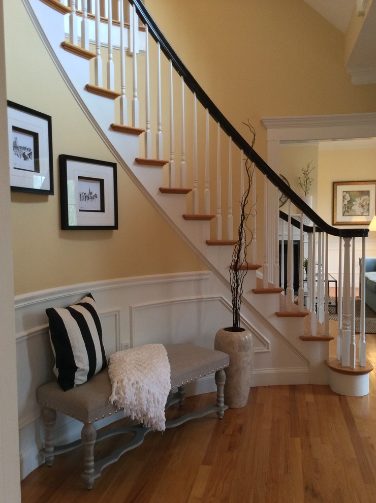 Inspiration for a mid-sized transitional foyer in Boston with yellow walls and medium hardwood floors.