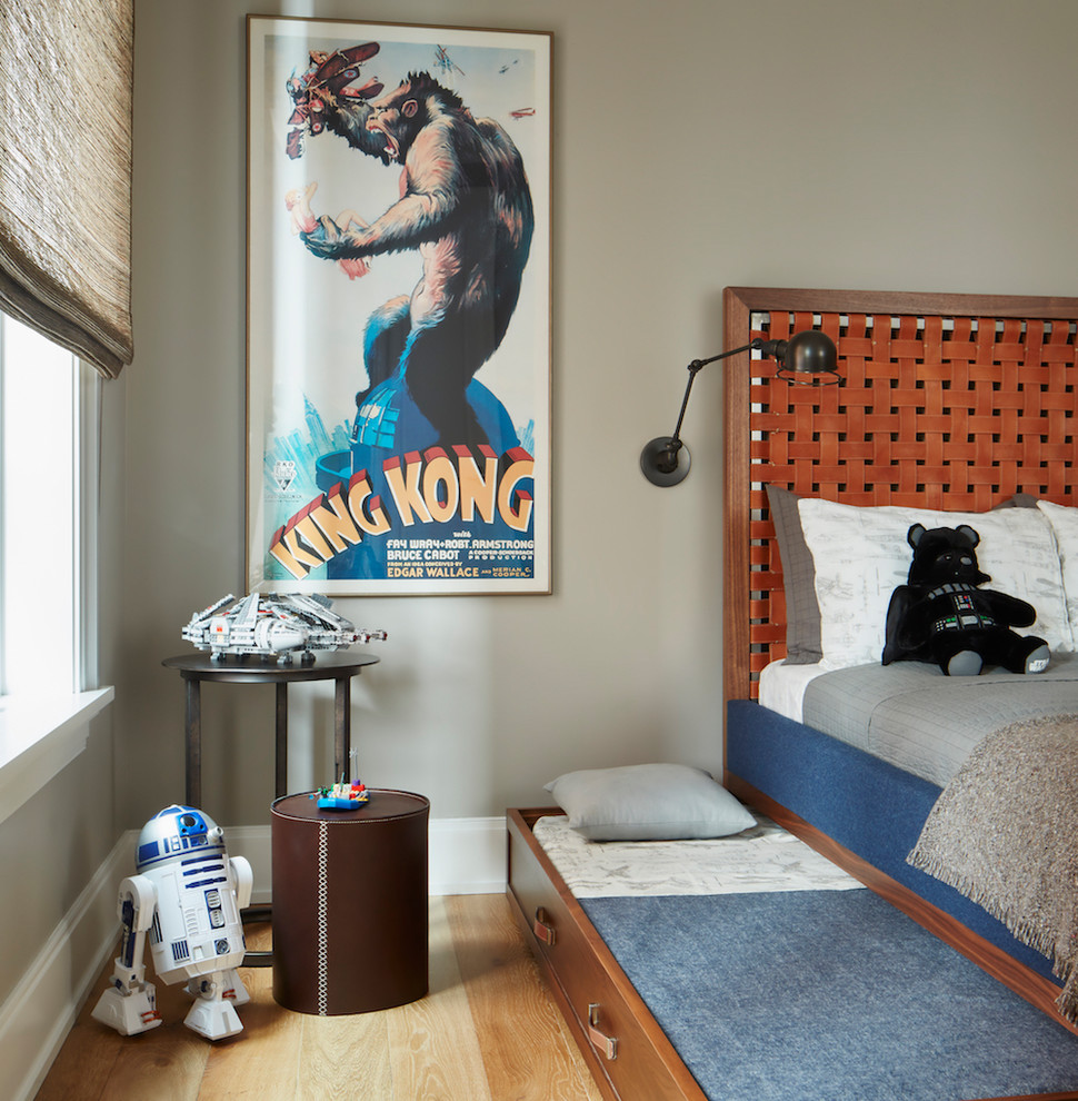 Photo of an expansive transitional kids' bedroom for boys in Chicago with grey walls and light hardwood floors.