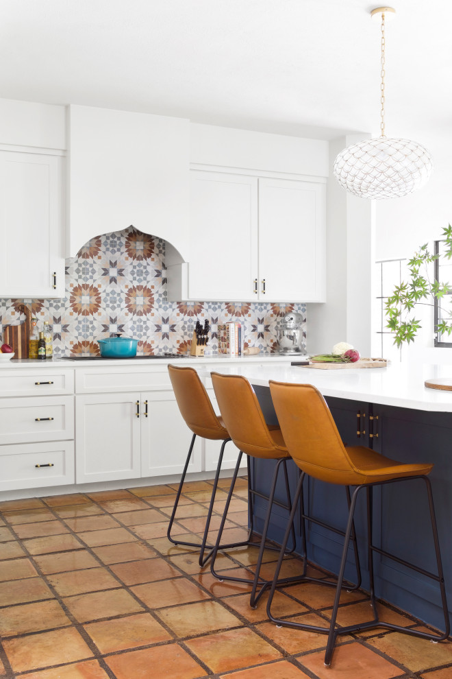 Mid-sized eclectic kitchen in Dallas with an undermount sink, shaker cabinets, blue cabinets, quartz benchtops, multi-coloured splashback, ceramic splashback, stainless steel appliances, ceramic floors, with island and white benchtop.