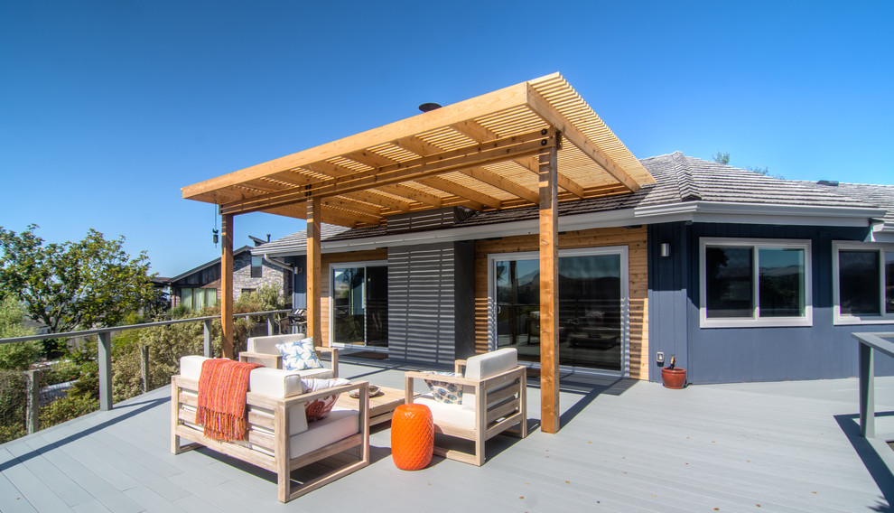 This is an example of a midcentury backyard deck in San Luis Obispo with a container garden and a pergola.