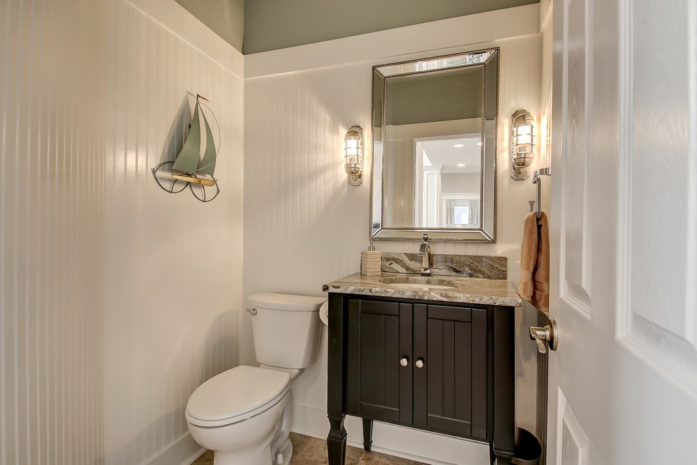 Design ideas for a mid-sized beach style powder room in Dallas with furniture-like cabinets, dark wood cabinets, a two-piece toilet, green walls, porcelain floors, an undermount sink, granite benchtops, multi-coloured floor and multi-coloured benchtops.