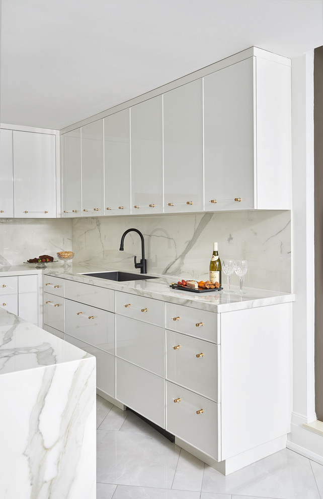Inspiration for a mid-sized contemporary u-shaped open plan kitchen in Toronto with an undermount sink, flat-panel cabinets, white cabinets, marble benchtops, white splashback, marble splashback, panelled appliances, porcelain floors, with island, white floor and white benchtop.