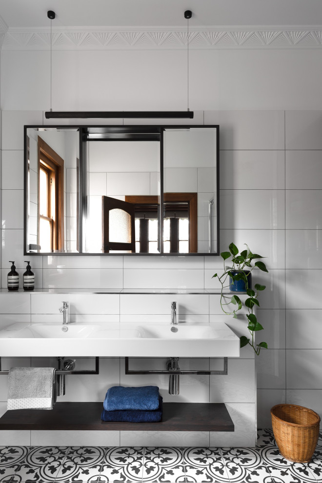 Transitional master bathroom in Melbourne with flat-panel cabinets, white cabinets, white tile, white walls, an integrated sink, multi-coloured floor, white benchtops, a double vanity and a floating vanity.