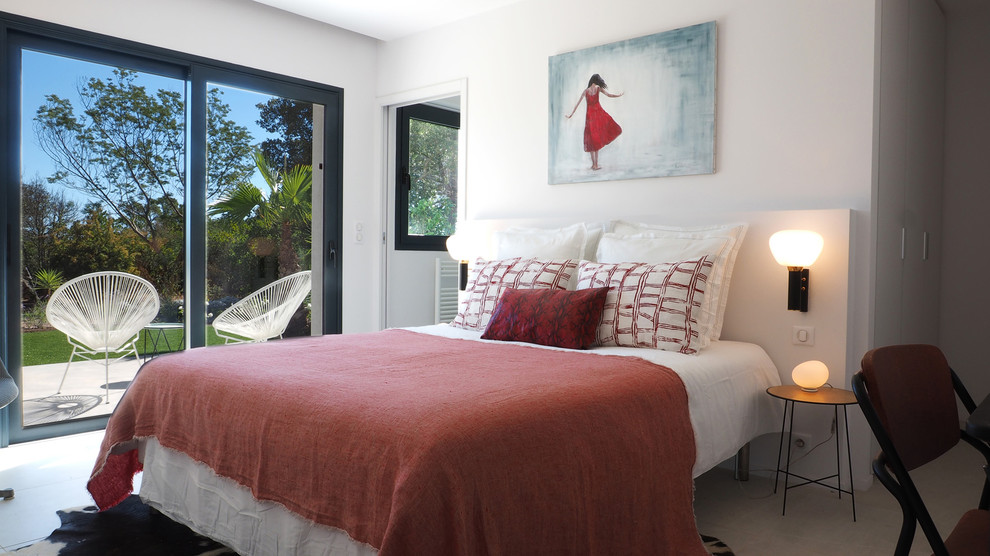 This is an example of a large modern master bedroom in Corsica with white walls, concrete floors and white floor.