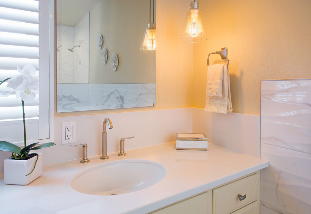 Mid-sized traditional master bathroom in Sacramento with shaker cabinets, beige cabinets, a claw-foot tub, a corner shower, a two-piece toilet, gray tile, white tile, stone tile, beige walls, marble floors, an undermount sink, solid surface benchtops, white floor and an open shower.