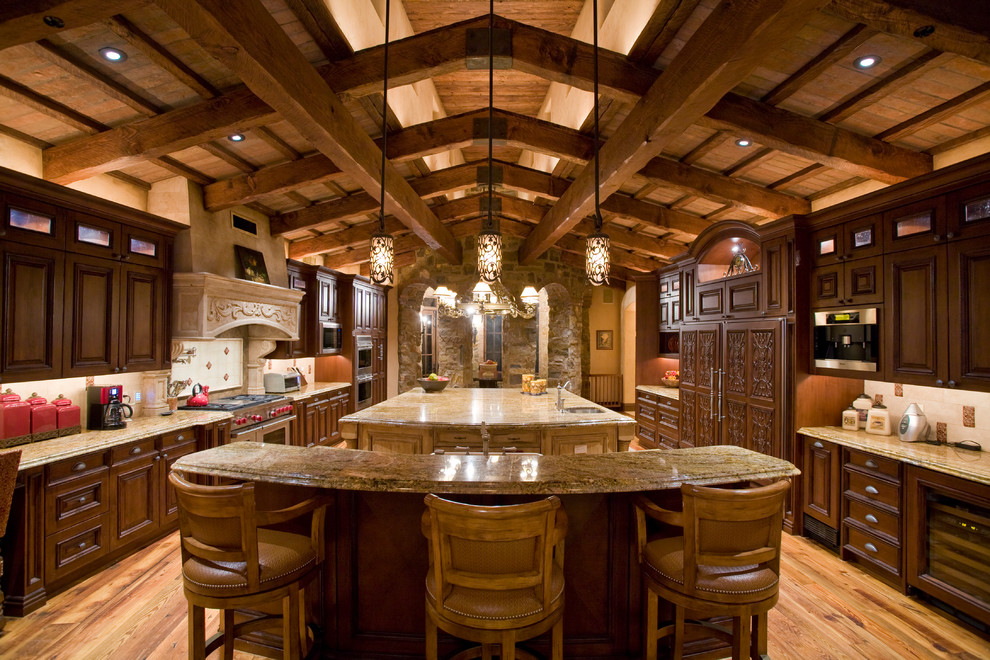 Inspiration for a large country galley eat-in kitchen in Phoenix with an undermount sink, open cabinets, dark wood cabinets, granite benchtops, beige splashback, porcelain splashback, stainless steel appliances, light hardwood floors and multiple islands.