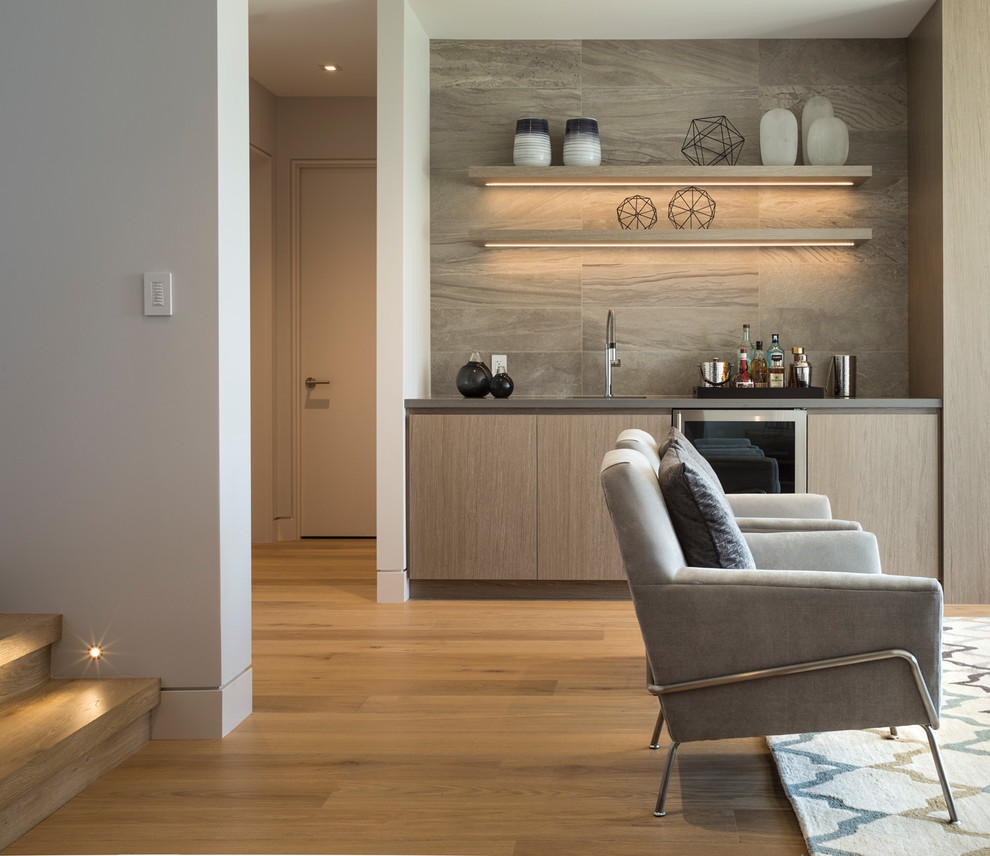 Inspiration for a large contemporary walk-out basement in Vancouver with white walls and medium hardwood floors.