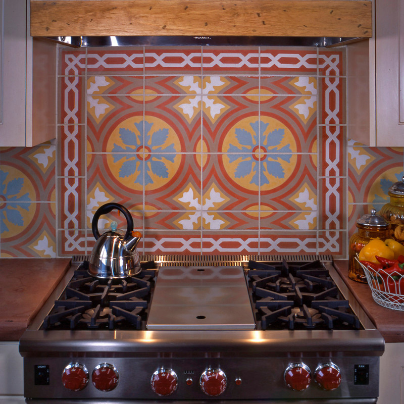 Example of a large mountain style u-shaped dark wood floor open concept kitchen design in Albuquerque with a farmhouse sink, raised-panel cabinets, distressed cabinets, concrete countertops, multicolored backsplash, cement tile backsplash, stainless steel appliances and an island