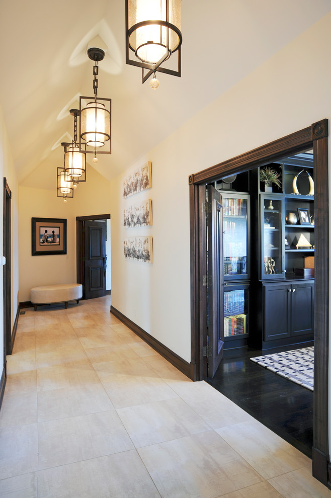 Large contemporary hallway in Columbus with beige walls, limestone floors and beige floor.