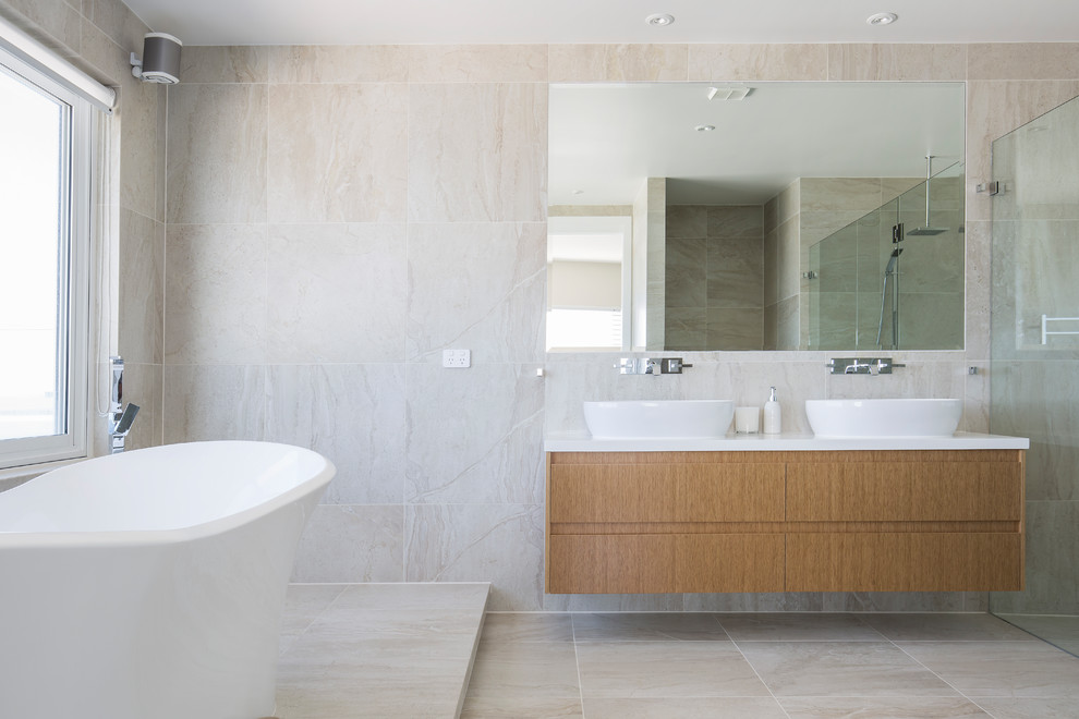 Photo of an expansive scandinavian master bathroom in Sydney with light wood cabinets, a freestanding tub, a double shower, multi-coloured tile, porcelain tile, white walls, porcelain floors, engineered quartz benchtops and an open shower.