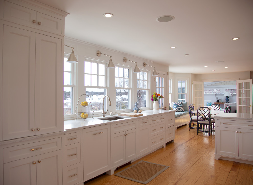 Eat-in kitchen - transitional galley light wood floor eat-in kitchen idea in Boston with shaker cabinets, granite countertops and white appliances