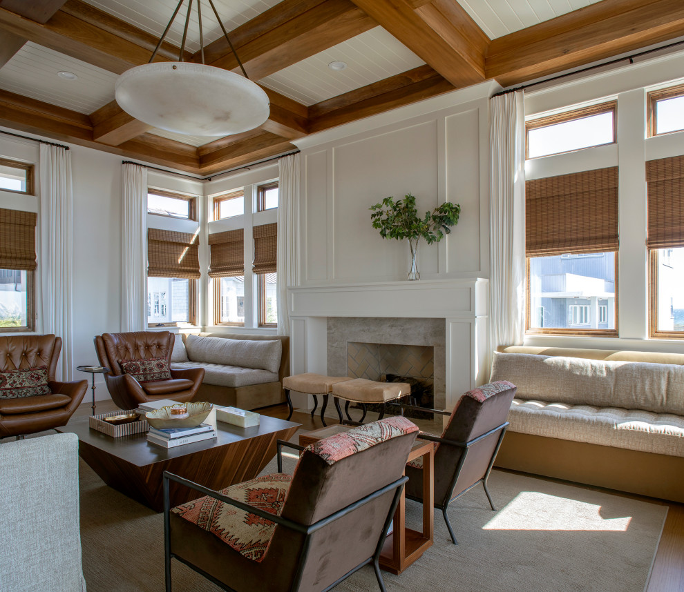 Photo of an expansive coastal open plan living room in Other with white walls, medium hardwood flooring, a standard fireplace, a wooden fireplace surround, brown floors and a coffered ceiling.