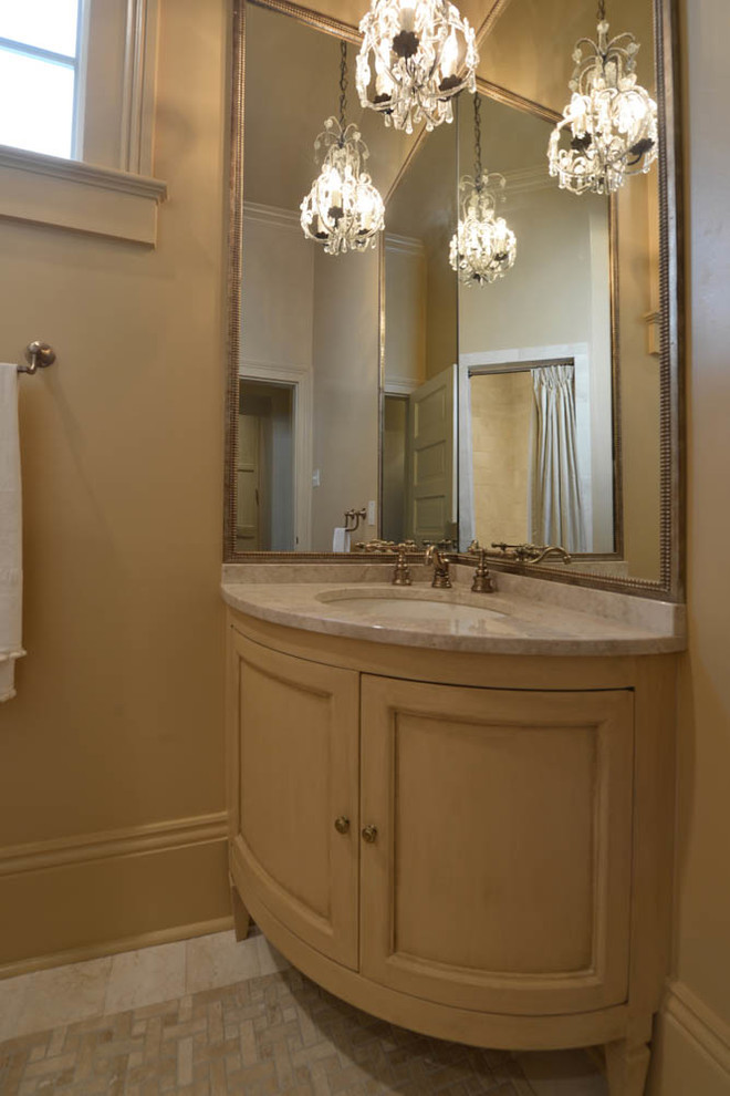 Inspiration for a small traditional powder room in New Orleans with mosaic tile floors, an undermount sink, furniture-like cabinets, light wood cabinets, beige tile, gray tile, white tile, marble benchtops and beige benchtops.