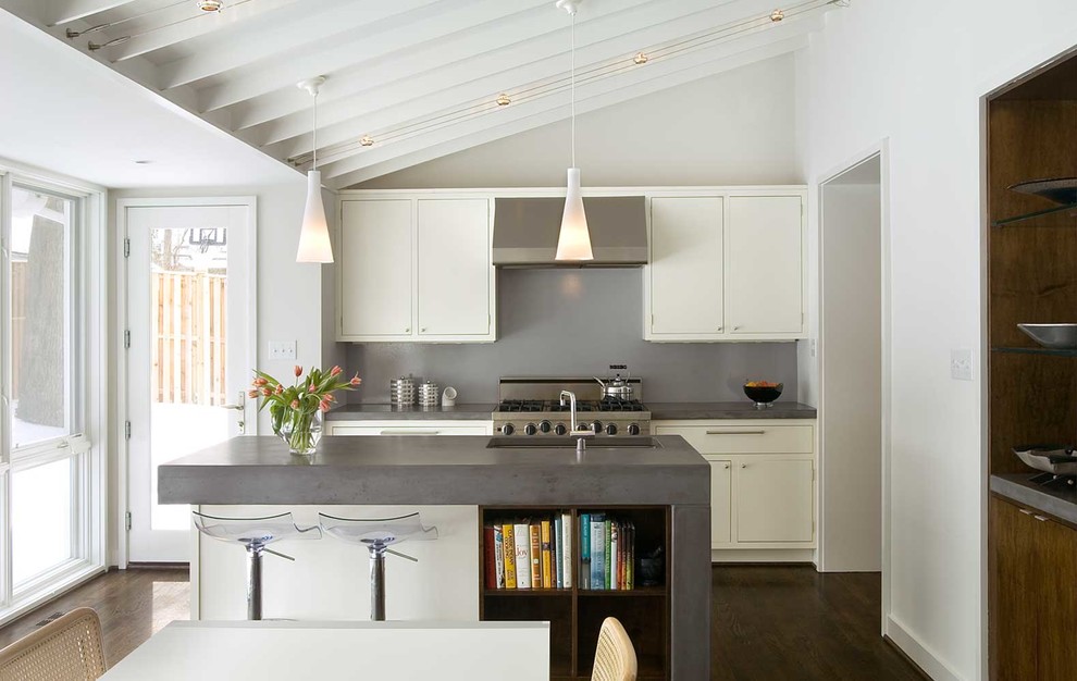 Inspiration for a contemporary eat-in kitchen in DC Metro with an undermount sink, flat-panel cabinets, white cabinets, concrete benchtops, grey splashback, stainless steel appliances, dark hardwood floors and with island.