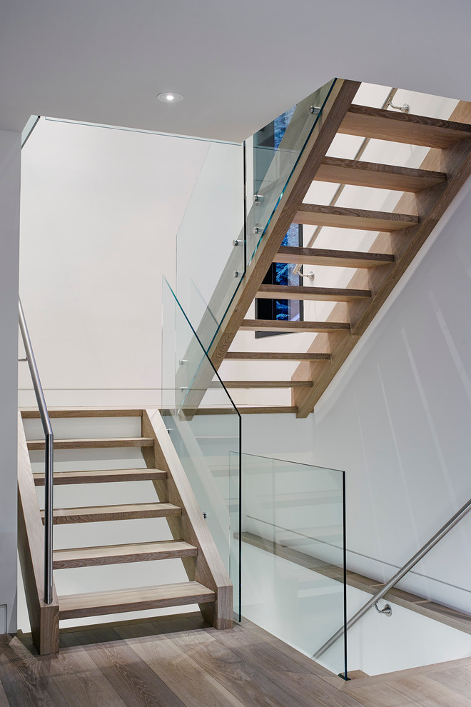 This is an example of a mid-sized contemporary wood floating staircase in Vancouver with open risers.