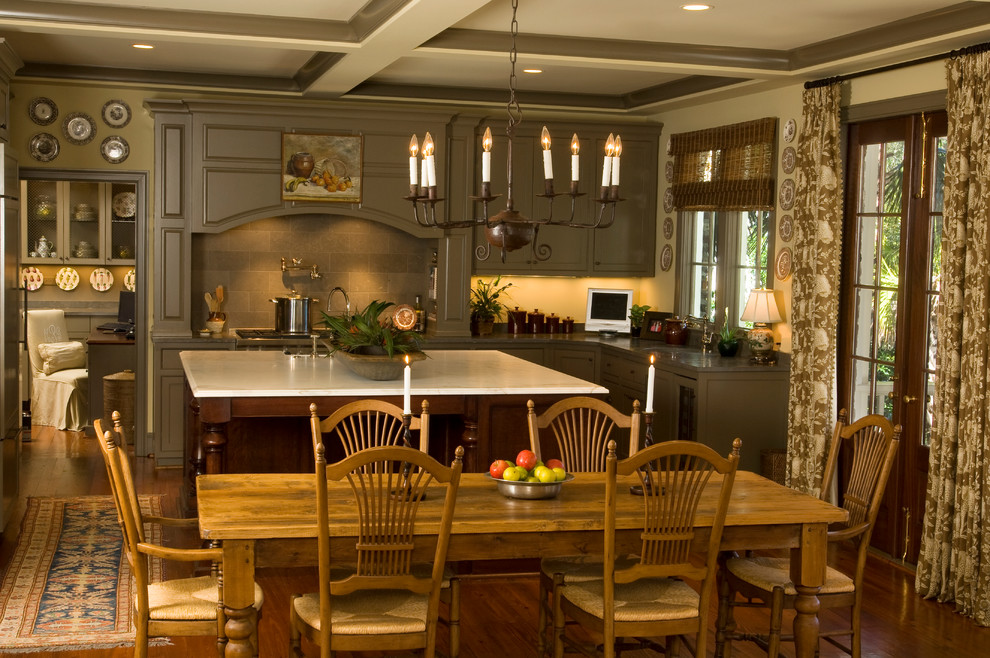 This is an example of a large traditional l-shaped eat-in kitchen in Charleston with beaded inset cabinets, green cabinets, panelled appliances, medium hardwood floors and with island.