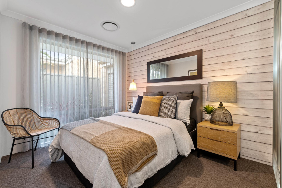 Photo of a contemporary bedroom in Perth with beige walls, carpet and brown floor.