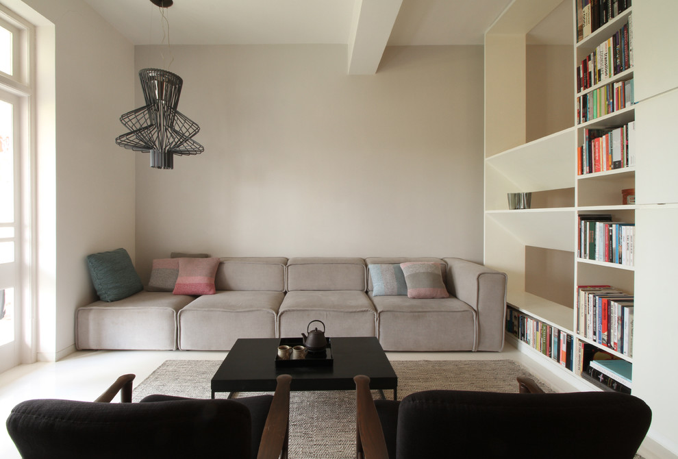 Inspiration for a contemporary Formal living room in Mumbai With Beige Walls, No Fireplace and No TV.
