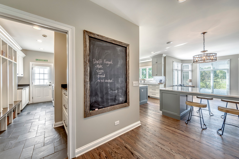Transitional open concept kitchen photo in Chicago with white backsplash, subway tile backsplash and two islands