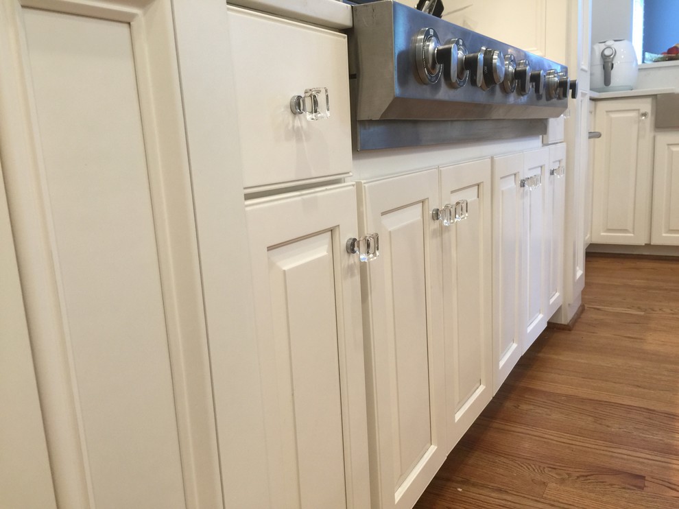 Example of a large transitional u-shaped medium tone wood floor open concept kitchen design in DC Metro with an undermount sink, raised-panel cabinets, white cabinets, quartzite countertops, stainless steel appliances and an island
