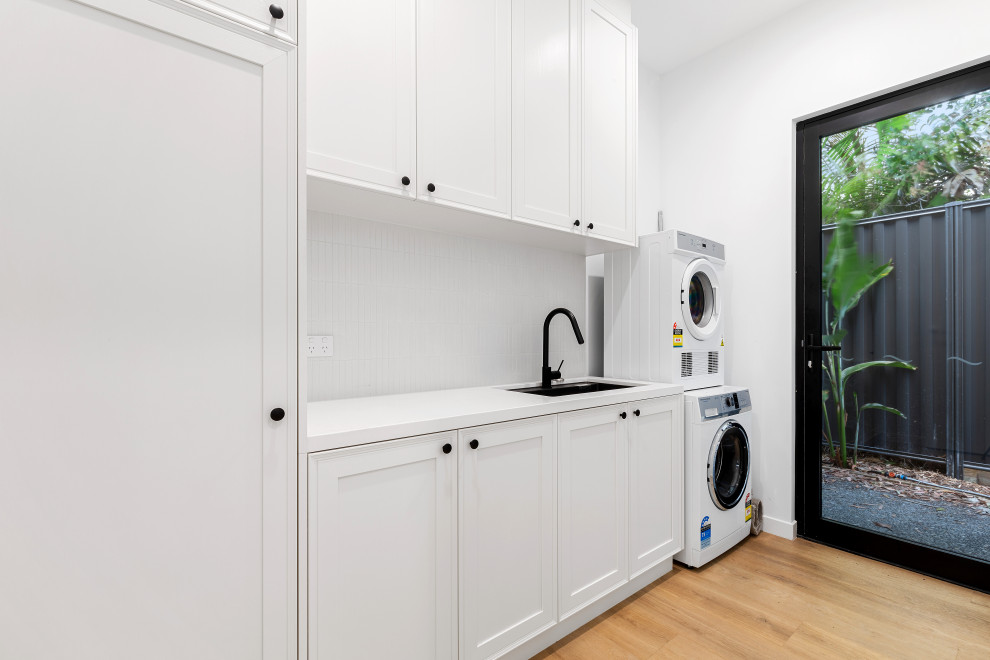 This is an example of a beach style laundry room in Sunshine Coast.