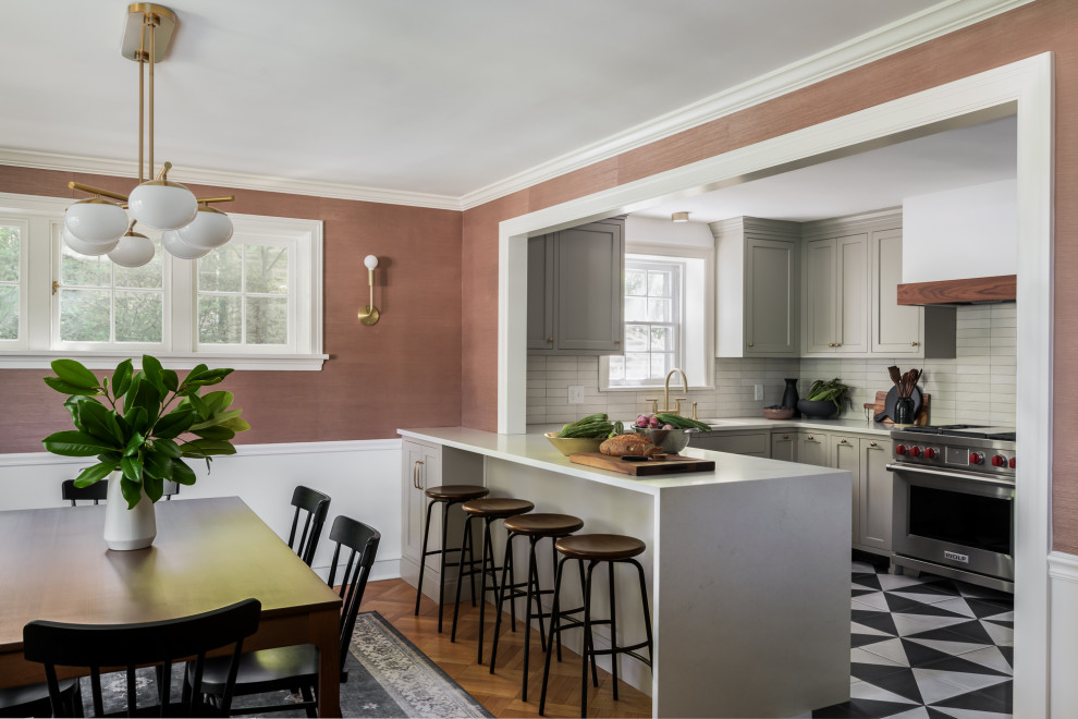 Inspiration for a mid-sized timeless u-shaped cement tile floor and multicolored floor eat-in kitchen remodel in Philadelphia with an undermount sink, shaker cabinets, gray cabinets, quartz countertops, beige backsplash, ceramic backsplash, stainless steel appliances, a peninsula and white countertops