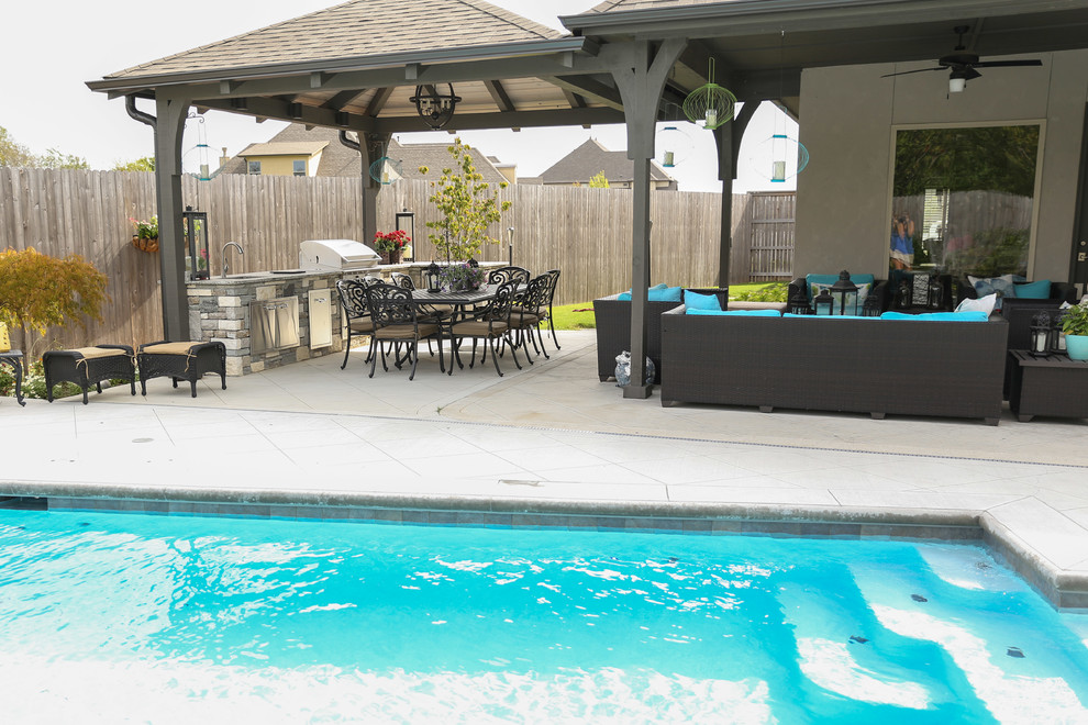 Example of a large transitional backyard tile patio kitchen design with a gazebo
