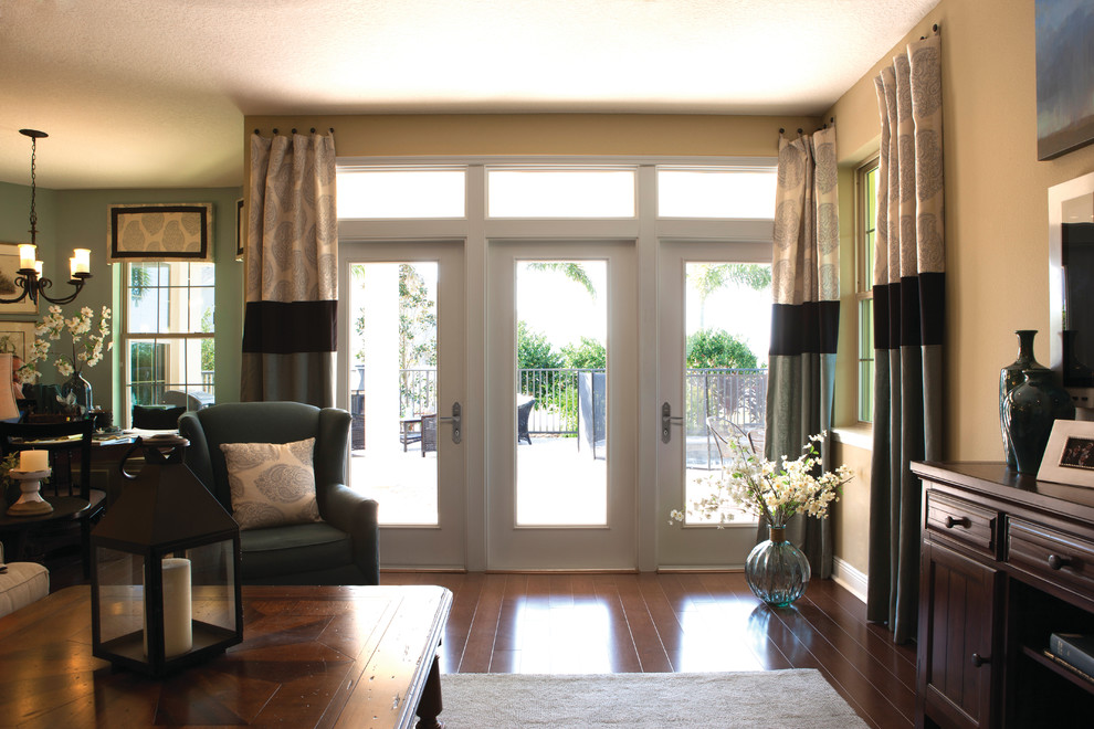 Entry hall - mid-sized transitional dark wood floor and brown floor entry hall idea in Boston with beige walls and a glass front door