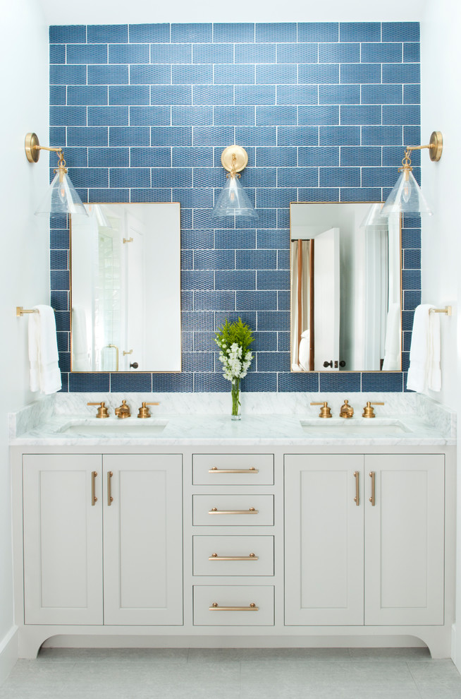 Bathroom - transitional blue tile and subway tile white floor bathroom idea with shaker cabinets, white cabinets, white walls, an undermount sink and white countertops