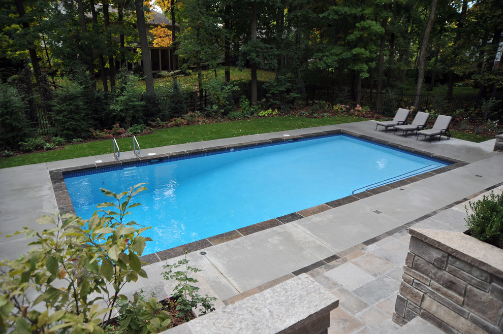 Huge minimalist backyard rectangular pool house photo in Toronto