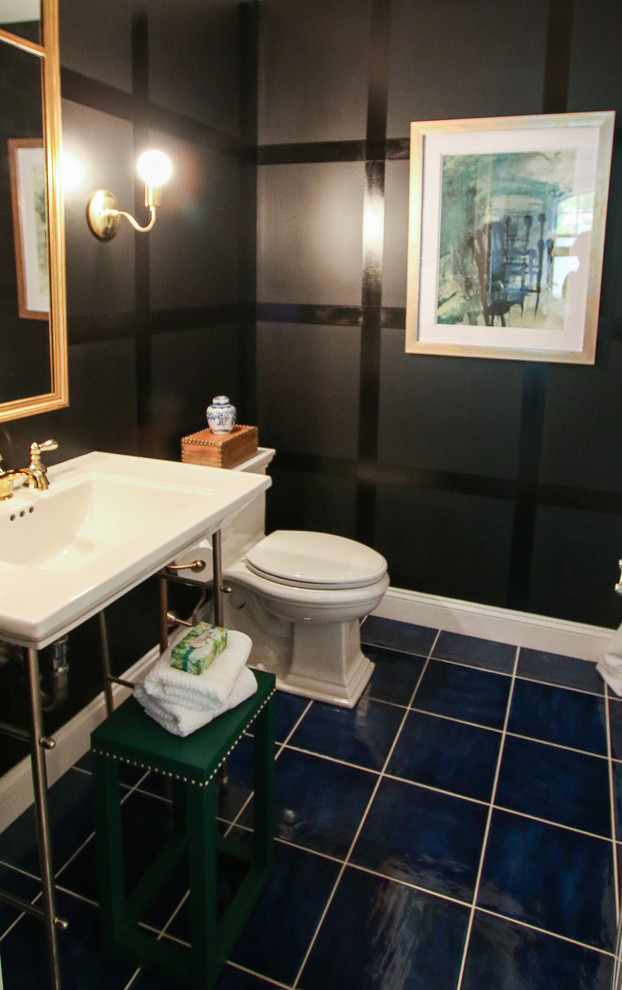 Small transitional 3/4 bathroom in New York with open cabinets, white cabinets, solid surface benchtops, a drop-in tub, a shower/bathtub combo, a two-piece toilet, white tile, ceramic tile, black walls, ceramic floors and a pedestal sink.