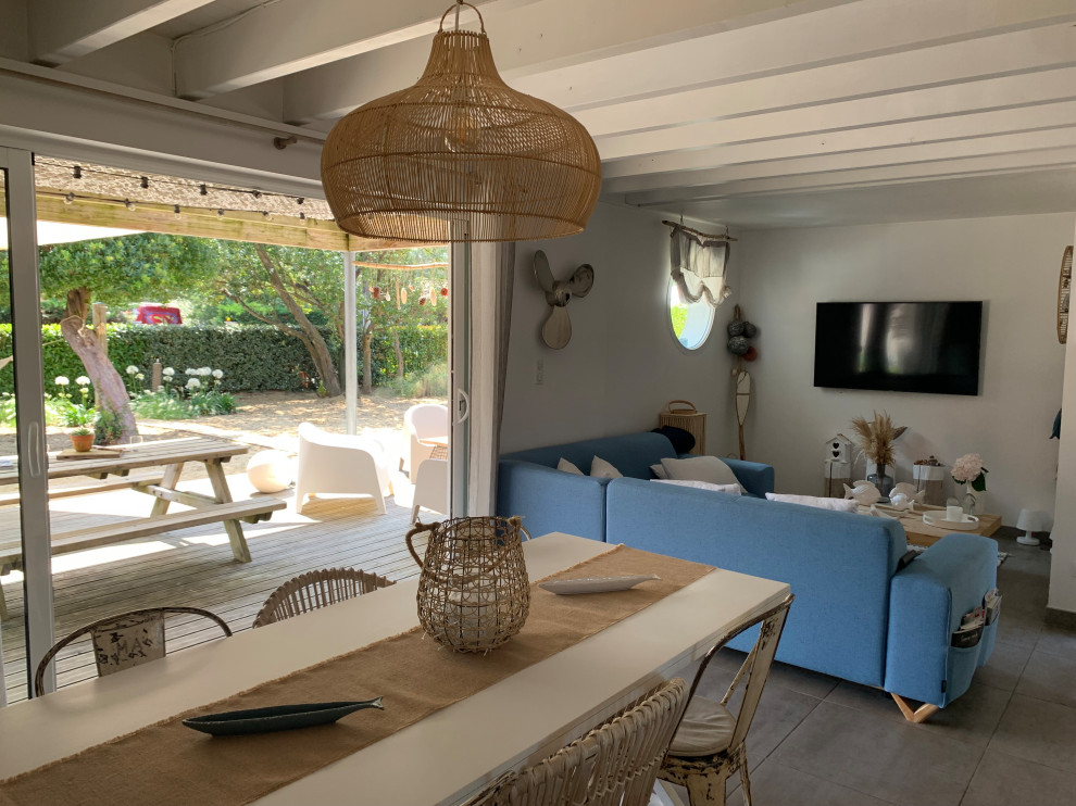 Inspiration for a medium sized beach style open plan games room in Bordeaux with white walls, ceramic flooring, no fireplace, a wall mounted tv, grey floors and a wood ceiling.