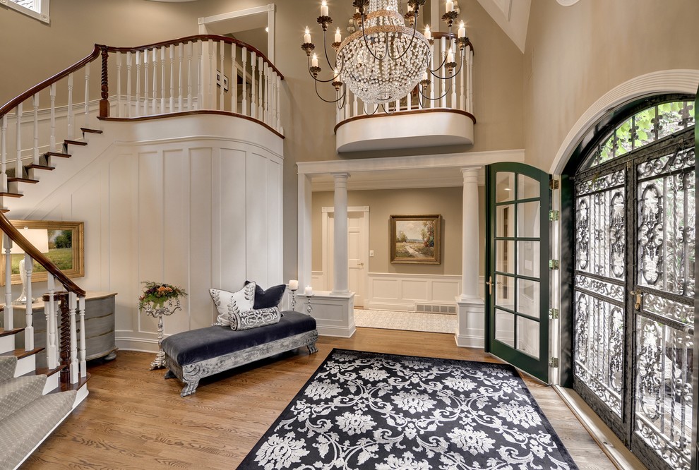 Inspiration for a mid-sized traditional foyer in Minneapolis with beige walls, light hardwood floors and a double front door.