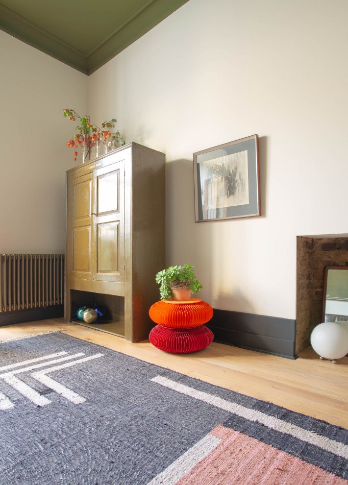 Großes Stilmix Wohnzimmer mit weißer Wandfarbe, braunem Holzboden und verstecktem TV in London