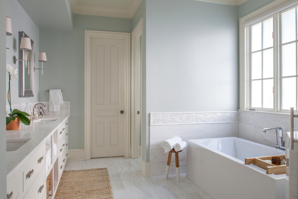 Design ideas for a large transitional master bathroom in Charlotte with recessed-panel cabinets, white cabinets, a freestanding tub, an alcove shower, blue walls, marble floors, an undermount sink and marble benchtops.