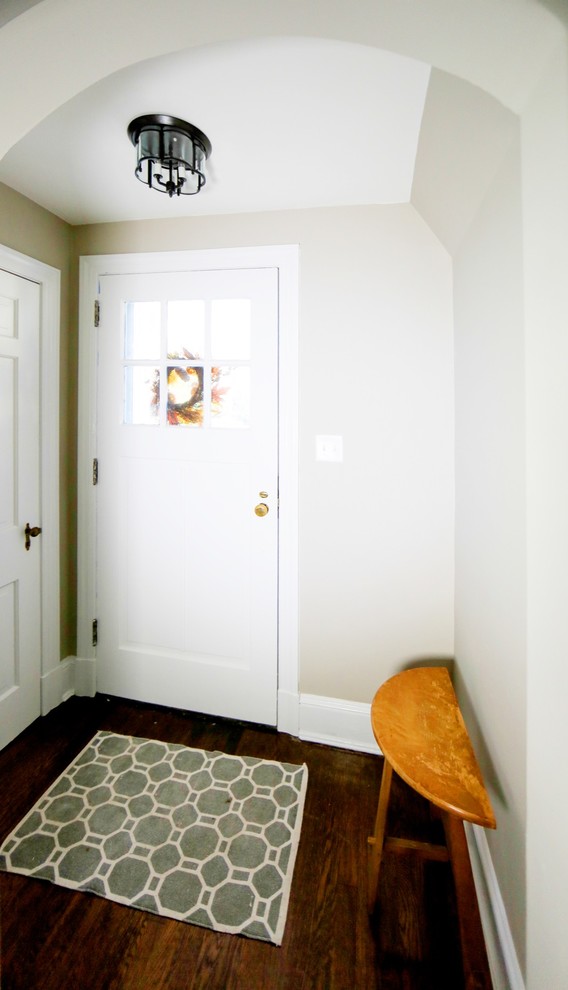 Foyer - small transitional dark wood floor foyer idea in Baltimore with beige walls and a white front door